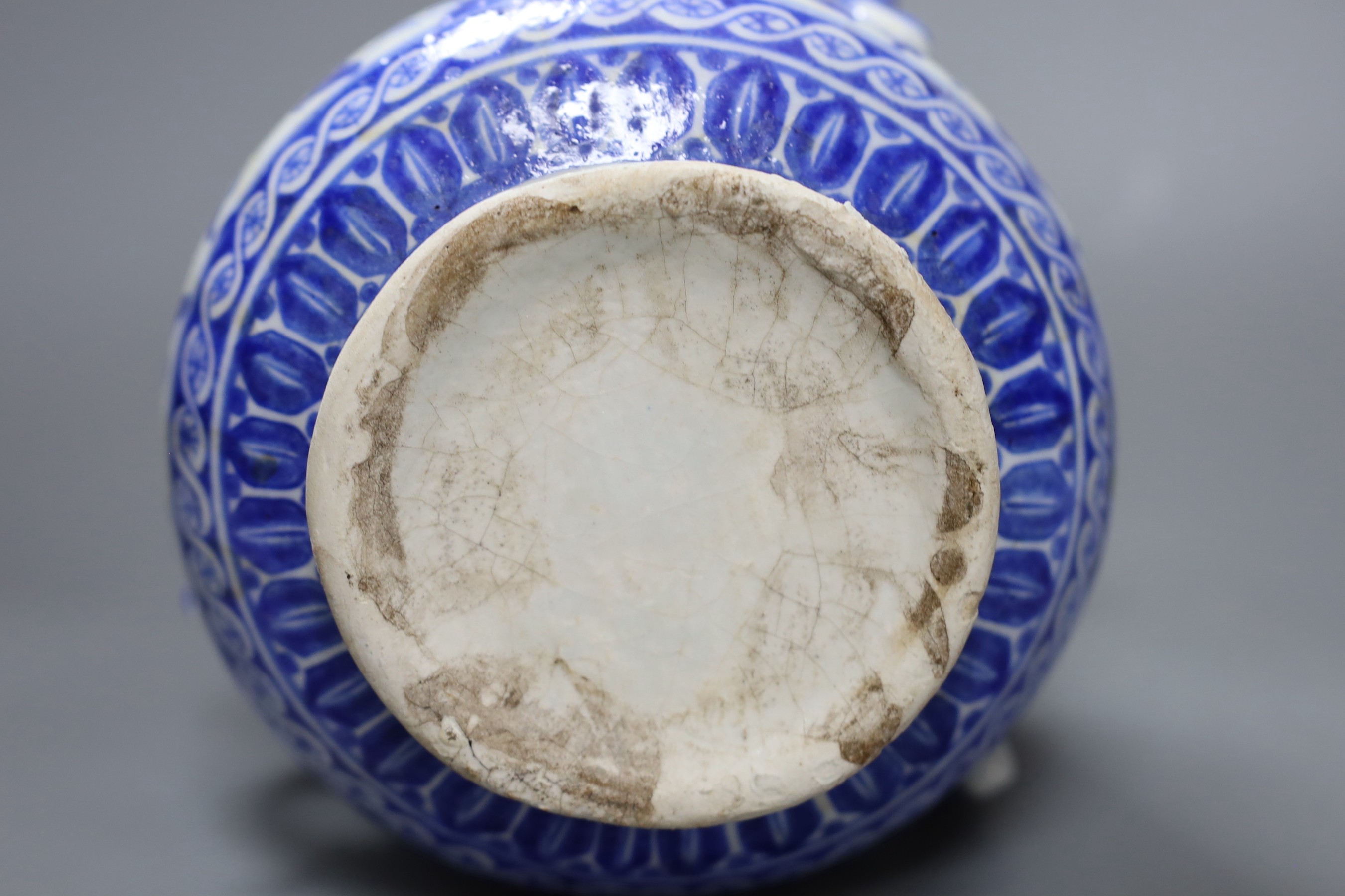 A three-handled blue and white Iznik pottery vase with floral motif, 22.5cm tall